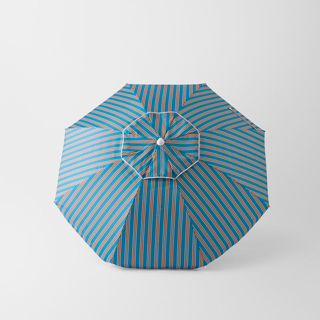 https://s3-ap-southeast-2.amazonaws.com/fusionfactory.commerceconnect.bbnt.production/pim_media/000/196/178/M_F_S25-26_Calabria-Stripe-Beach-Umbrella_Blue-Rust_26530101_V2_SI.jpg?1750229855